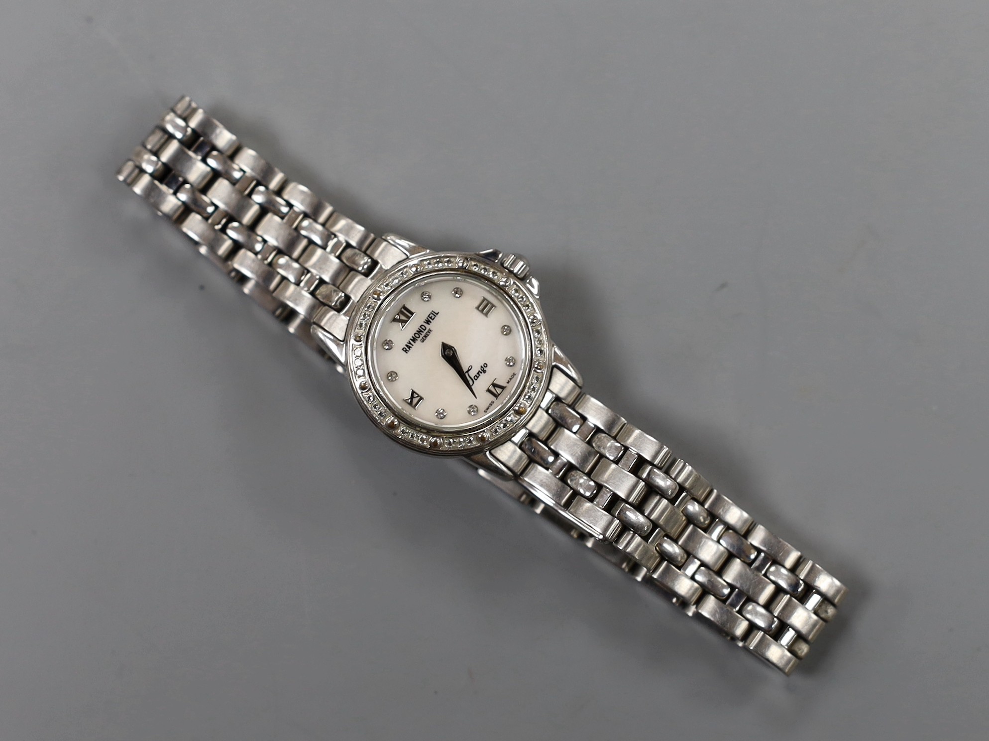 A lady's modern stainless steel Raymond Weil quartz wrist watch and bracelet, with diamond chip set bezel and mother of pearl dial with diamond set markers, with box.